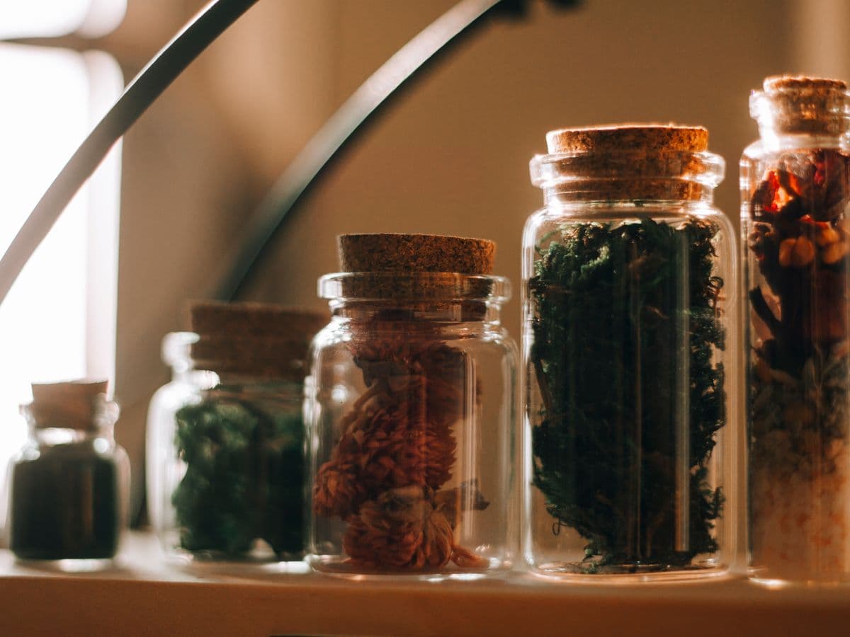 Apothecary jars filled with natural dried herbs