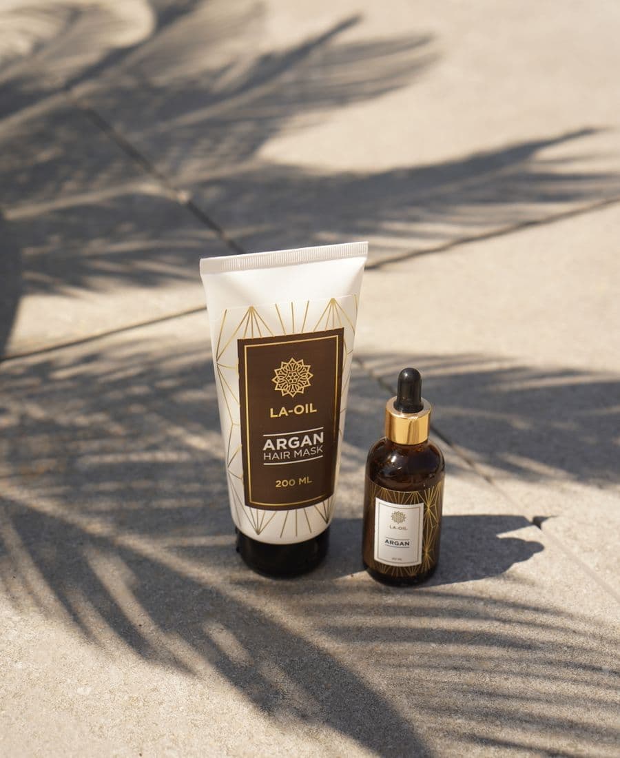 Premium argan oil products with palm leaf shadows
